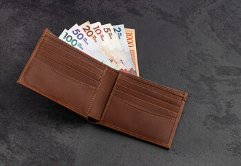Colombian money in paper bills in wallet - Pesos currency