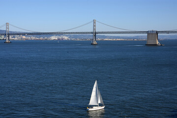San Francisco Oakland Bay Bridge and sailing yacht 