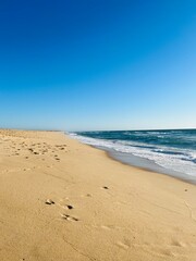 Fototapeta na wymiar Sand beach, sea coastline, pure blue sky, natural seascape background, no people