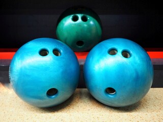 Three blue and Green bowling balls