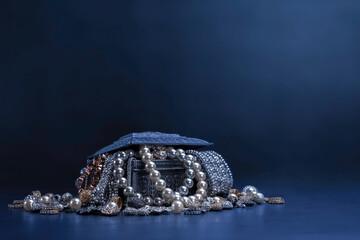 Various jewels in a silver box on black background