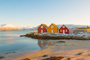 Fototapete Rund Traditional red and yellow wooden norwegian cabins with ground on the roof. Tromso, Norway © johnkruger1
