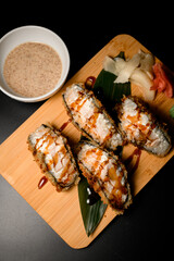 Top view close up of sushi rolls tempura sandwich with brown sauce