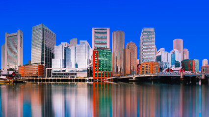 Fototapeta premium Boston City Skyline, skyscrapers and water reflections on the Charles River with the Blue Sky backgrounds in Massachusetts, USA