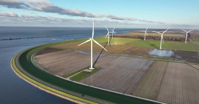 Rural area along the water line, wind turbines, creating electricity. Birds eye view.