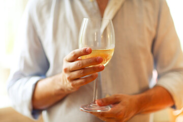 Man with glass of delicious wine indoors