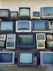 old televisions stacked on top of each other