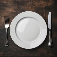 an empty plate with knife and fork on wooden background
