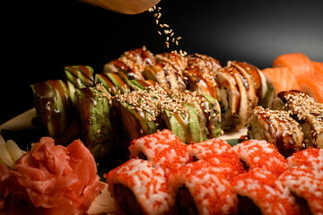 Close-up photo of sushi rolls green dragon with avocado and seared philadelphia with tuna sprinkled...