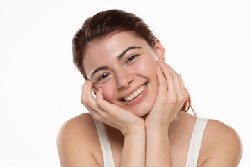 Fototapeta premium a young happy redhead woman without makeup with long hair on a white background