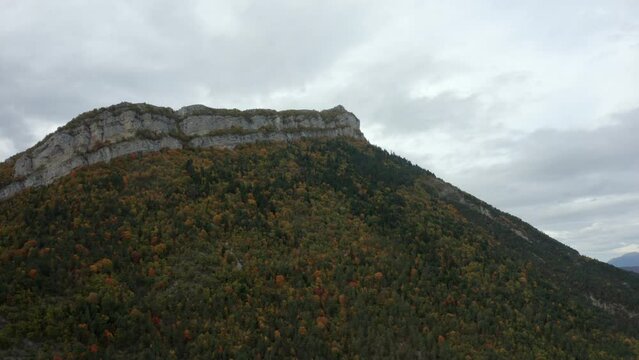 Aerial Panning Scenic View Of Trees On Rock Formations At Rhone-Alpes Under Cloudy Sky - Isere, France