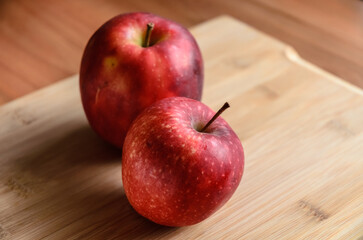 Red and yellow apples on wooden cutting board in the kitchen, healthy diet Vitamin C fruit