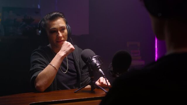 Androgyne girl is a guest on the podcast. A lesbian woman is talking to a journalist, crying and complaining. They discuss psychology and LGBT issues on a radio show. Female butch is talking to a DJ.
