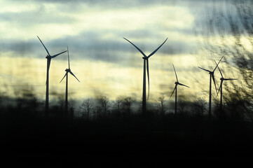 Industry wind energy turbine at sunset. Renewable windpower electricity power.