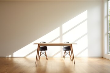 Two chairs and a table in a room with sunlight shining through a window