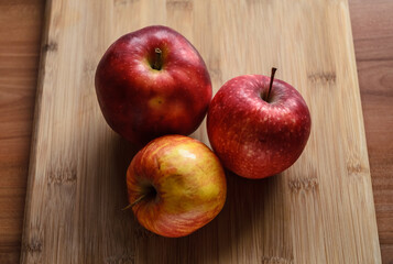 Red and yellow apples on wooden cutting board in the kitchen, healthy diet Vitamin C fruit