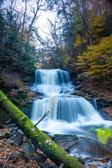 Obraz premium Cascade of waterfalls in a mountain gorge, fast flowing water, long exposure