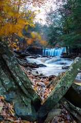 Cascade of waterfalls in a mountain gorge, fast flowing water, long exposure