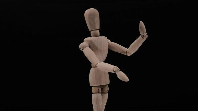 Wood mannequin over black background rotating