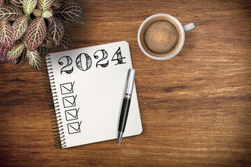 New year 2024 resolutions on notebook at desk