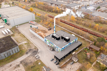 Drone photography of biomass power plant and biomass storage place during autumn day