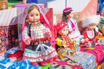 Dolls in ethnic costumes of peoples of Urals, traditional Irbit fair, Russia.