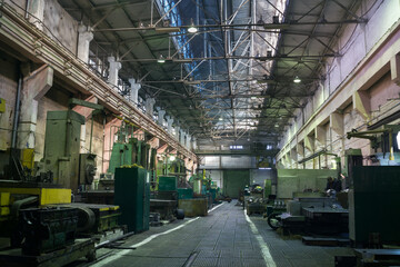 Industrial interior of heavy machinery workshop, large hall with machines, tools for metalwork, manufacturing production line, workspace for manual labor, metal industry background, no people.