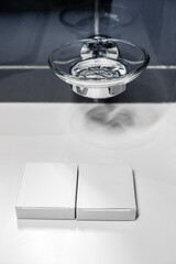 Small packages, boxes for soap or hygiene products with space for text or label against the background of a soap dish in the bathroom.