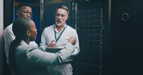 Technician, teamwork and tablet in server room for programming, engineering and cyber security solution. Senior manager, business people and group in data center with digital technology for planning - Powered by Adobe