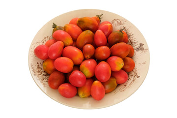 Tomatoes in a clay plate isolate on white background. Red tomato in rustic bowl.