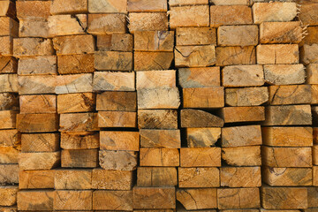 Stacked lumber pile, close-up of cut wood logs for timber industry. Forestry texture background, sawn wooden beams in warehouse, construction material. Natural hardwood, carpentry resource storage.