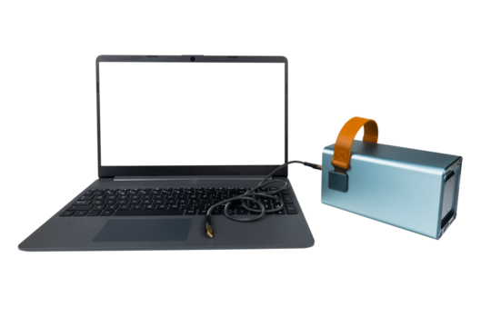 A laptop with a blank transparent screen next to a large power bank (charging station) with a USB cable on a transparent background. Mobile power supply