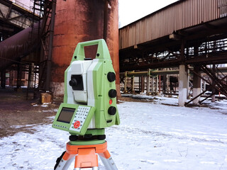 Total station at work. Electronic total station - modern geodetic instrument combines engineering...
