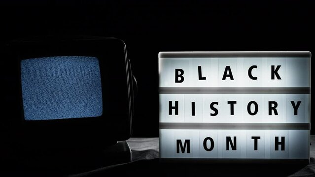 Black History month signboard and static tv