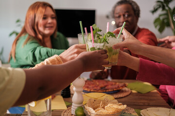 Toast between friends during a joint meal. Concept: diversity, fun, happiness