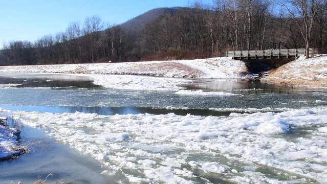 Handheld video of cold weather frizing over river 4k