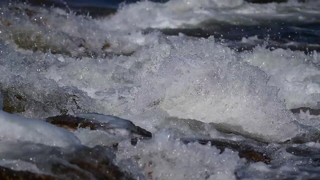 North Platte River close up. Fast current does not let the water freeze. Some rocks being exposed to the air will freeze. This river runs trough part of Casper Wyoming in North America. 