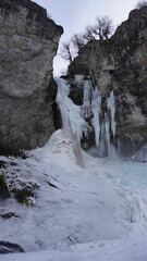 Fototapeta na wymiar waterfall and frozen river in winter argentina