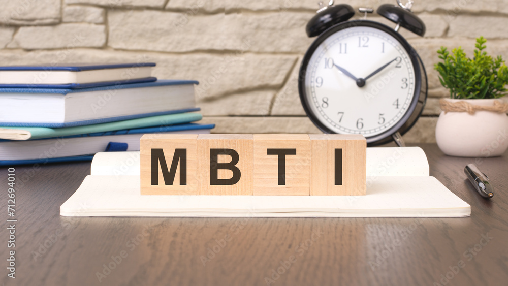 Poster cubes form the word mbti. it signifies the understanding and application of the myers-briggs type in