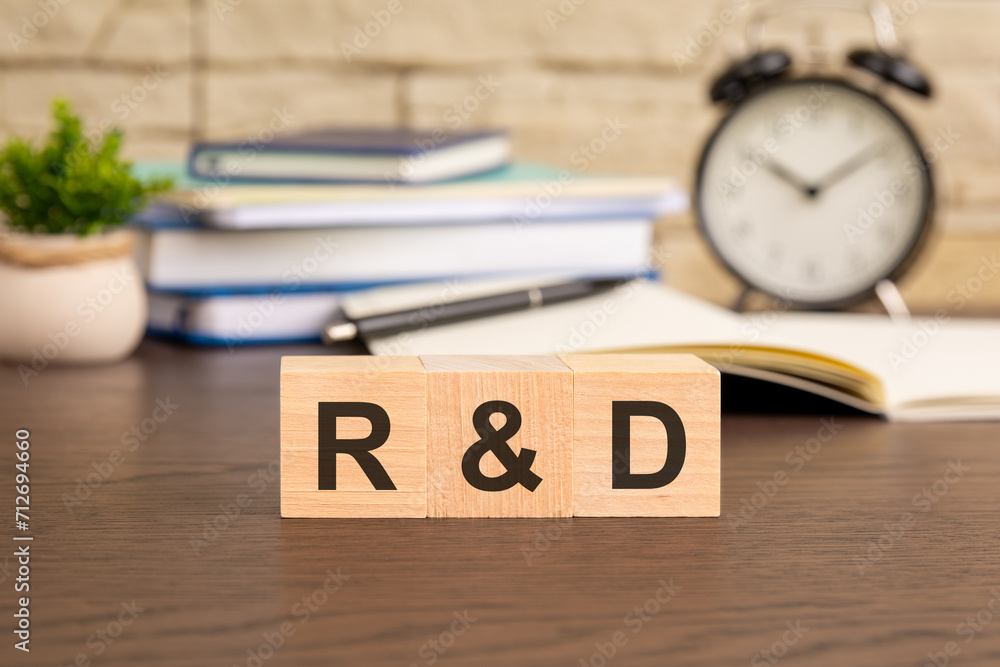 Poster r and d - word concept from wooden blocks. concept: illustrating an innovative workspace where empha