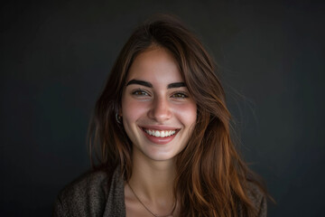 A woman with long brown hair is smiling for the camera