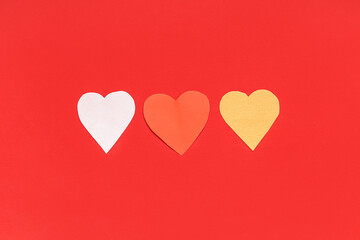 Paper hearts on red background. Valentine's day celebration