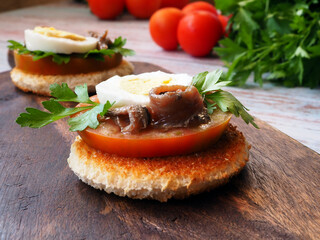 Spanish Tapas Delight: Anchovies, Egg, and Herbs on Toast