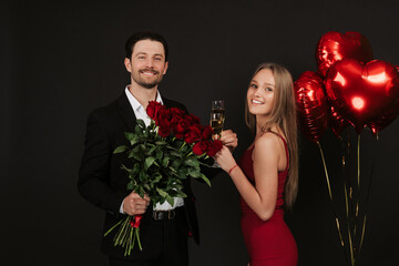 True love. Beautiful young couple drinking champagne and smiling while sitting face to face