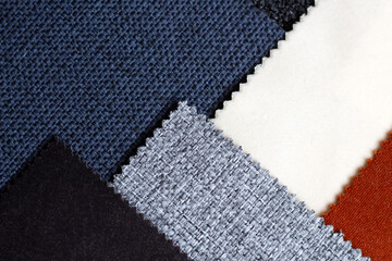 Scraps of colorful upholstery fabric in  different colors. Close up to linen fabric