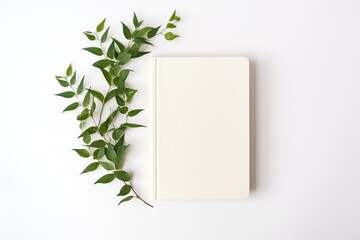Old retro book with green leafs on white background - obrazy, fototapety, plakaty