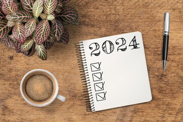 New year 2024 resolutions on notebook at desk