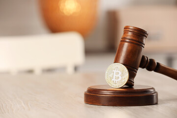 Law concept. Gavel and bitcoin on wooden table, closeup. Space for text