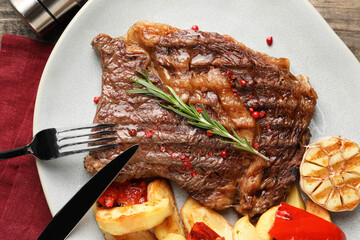 Delicious grilled beef steak and vegetables served on table, top view