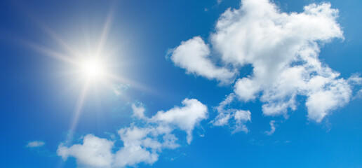 Naklejka na ściany i meble Bright sun on beautiful blue sky with white clouds.